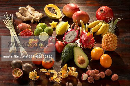 Exotic fruit on dark wooden background (still life)