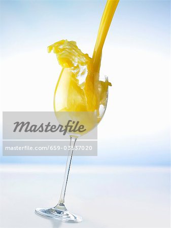 Download Pouring Orange Juice Into A Glass Splash Stock Photo Masterfile Premium Royalty Free Code 659 03537020 PSD Mockup Templates
