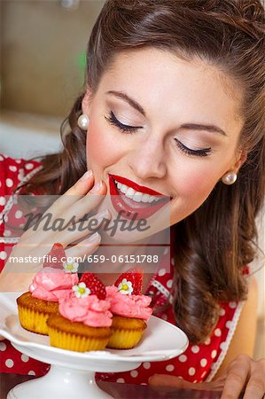 A retro-style girl with strawberry muffins A retro-style girl with strawberry muffins