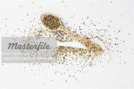 Dried oregano on a spoon and next to it