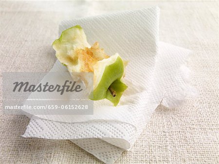 An apple core on kitchen paper