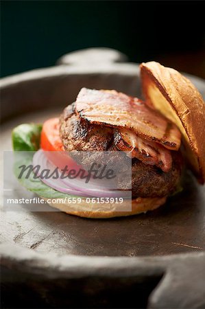 Grilled Hamburger with Bacon, Tomato, Onion and Lettuce on a Toasted Bun