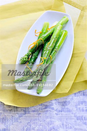 A green asparagus with orange zest