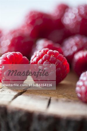 Raspberries on a wooden surface (close-up)