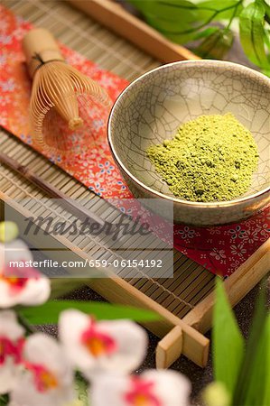 Japanese Matcha Green Tea Powder in a Bowl on Tray; Flowers