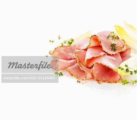 Boiled ham with a mustard crust, sliced