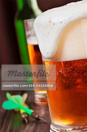 Foam Spilling Over the Top of a Glass of Beer Foam Spilling Over the Top of a Glass of Beer