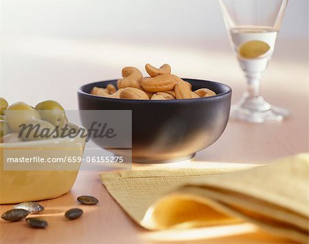 Olives, cashews and Martini with an olive