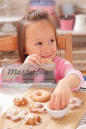 A girl eating freshly baked Christmas biscuits