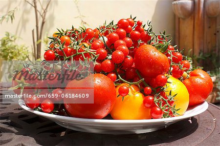 Large Platter of Various Tomatoes on Outdoor Table