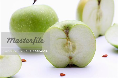 Granny Smith apples, whole and halved