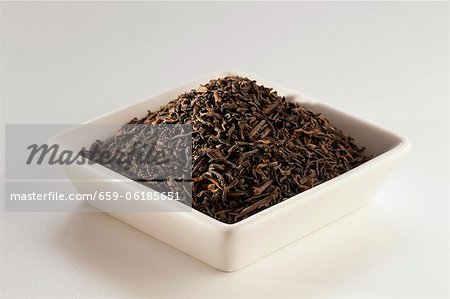 Pu Erh Loose Tea in a White Dish; White Background