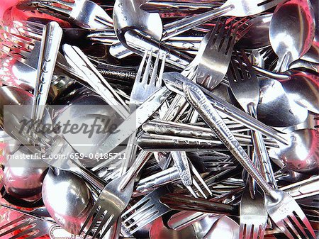 A pile of freshly washed cutlery A pile of freshly washed cutlery