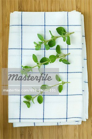 Oregano sprigs on a tea towel Oregano sprigs on a tea towel
