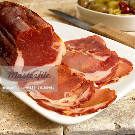Partially Sliced Dried Cured Spanish Pork Loin on a Platter
