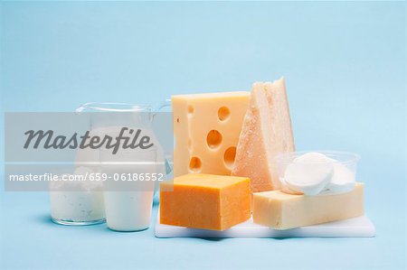 Various milk products (cheese, yoghurt, quark, milk) on a blue background