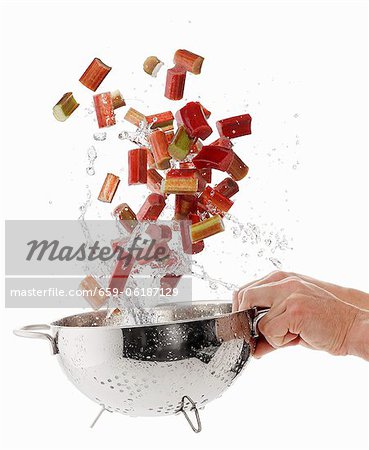 Washing rhubarb slices in a colander