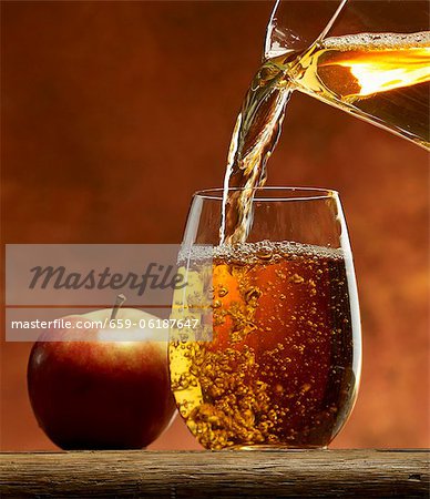 Download Pouring Apple Juice Into A Glass Stock Photo Masterfile Premium Royalty Free Code 659 06187647 PSD Mockup Templates