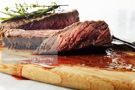 Sliced Steak on a Cutting Board with Juices