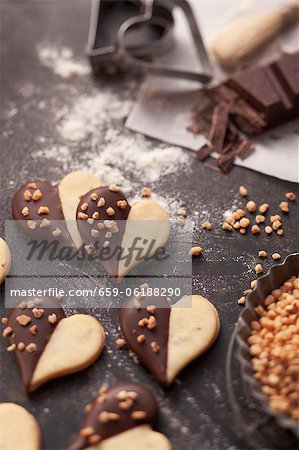 Heart-shaped biscuits with chocolate glaze and chopped nuts