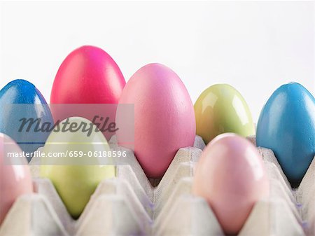 Coloured eggs in an egg box