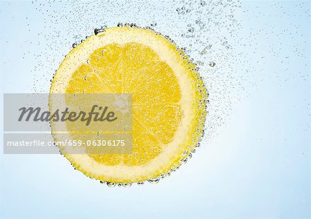 A lemon slice in water with air bubbles A lemon slice in water with air bubbles