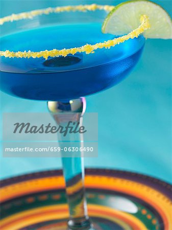 Blue Margarita in a Salted Rim Glass with a Lime Garnish Blue Margarita in a Salted Rim Glass with a Lime Garnish