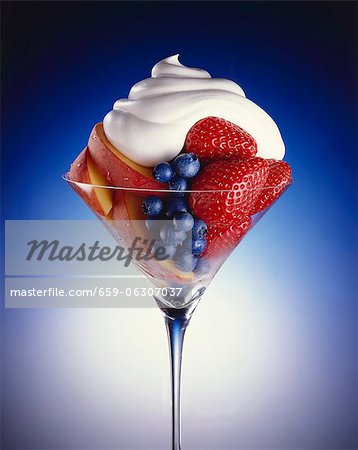 Fresh Fruit Salad in a Stem Glass Topped with Whipped Cream