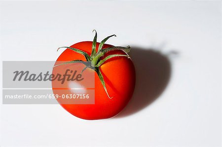 A tomato casting a shadow