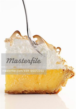 Lemon meringue pie with a fork