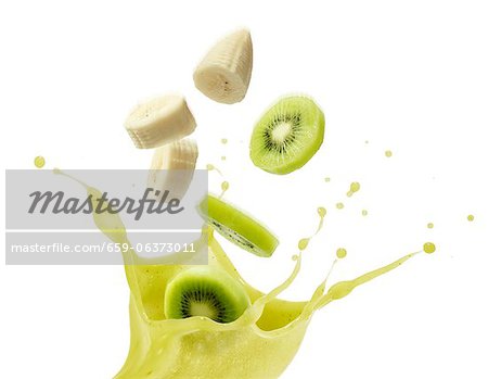 A splash of kiwi juice with slices of kiwi and banana