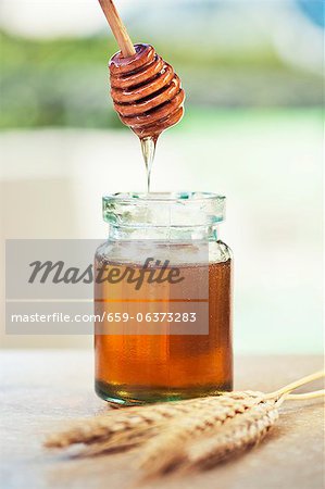 Jar of honey with honey dipper