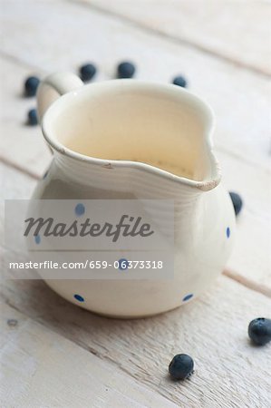 A jug of milk with blueberries