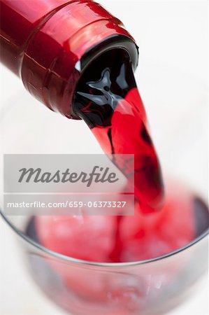 Pouring red wine into a glass