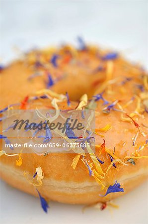 A doughnut decorated with dried flowers