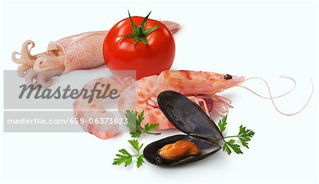 An arrangement of seafood and a tomato