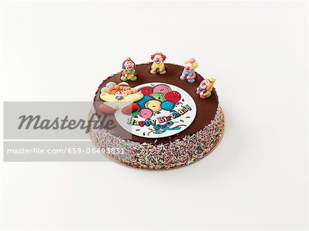 A birthday cake decorated with clowns A birthday cake decorated with clowns