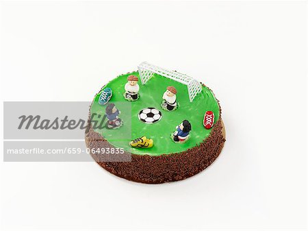 A birthday cake decorated with football motifs