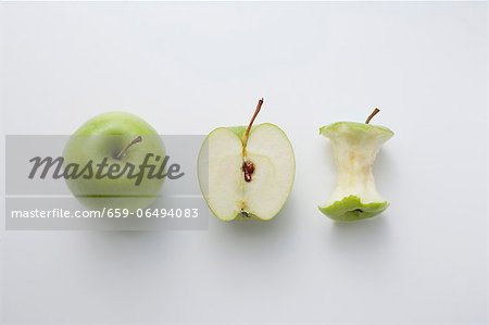 A whole apple, half an apple and an apple core