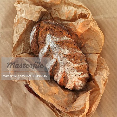 A loaf of bread on brown paper