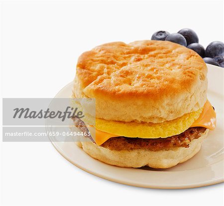 Sausage Egg and Cheese Breakfast Sandwich on a Biscuit; White Background Sausage Egg and Cheese Breakfast Sandwich on a Biscuit; White Background