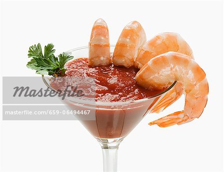 Shrimp Cocktail Served in a Stem Glass; White Background Shrimp Cocktail Served in a Stem Glass; White Background
