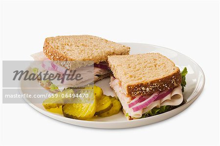 Turkey Sandwich on Wheat Bread; Halved with Pickles Turkey Sandwich on Wheat Bread; Halved with Pickles