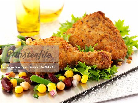 Breaded chicken legs with sweetcorn and beans