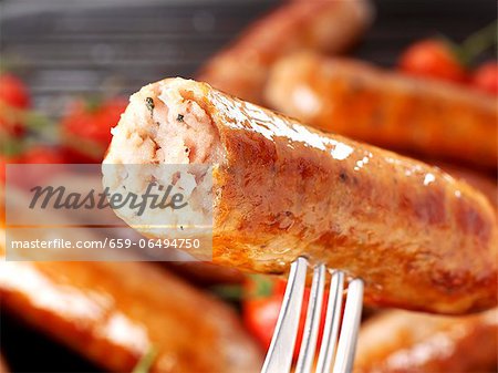 A Cumberland sausage on a fork (close-up)