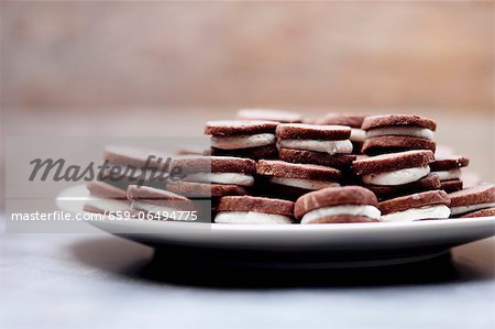 Cream-filled chocolate cookies on a plate