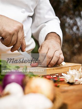 A chef slicing a chilli pepper A chef slicing a chilli pepper