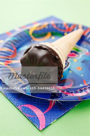 A marshmallow cone on a colourful plate