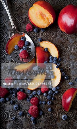Raspberries, blueberries and sliced red plums