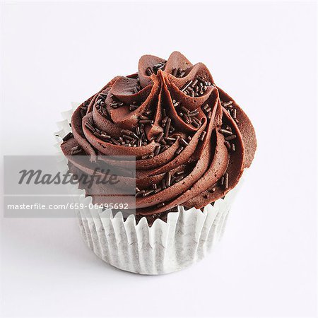 A chocolate cupcake on a white surface A chocolate cupcake on a white surface